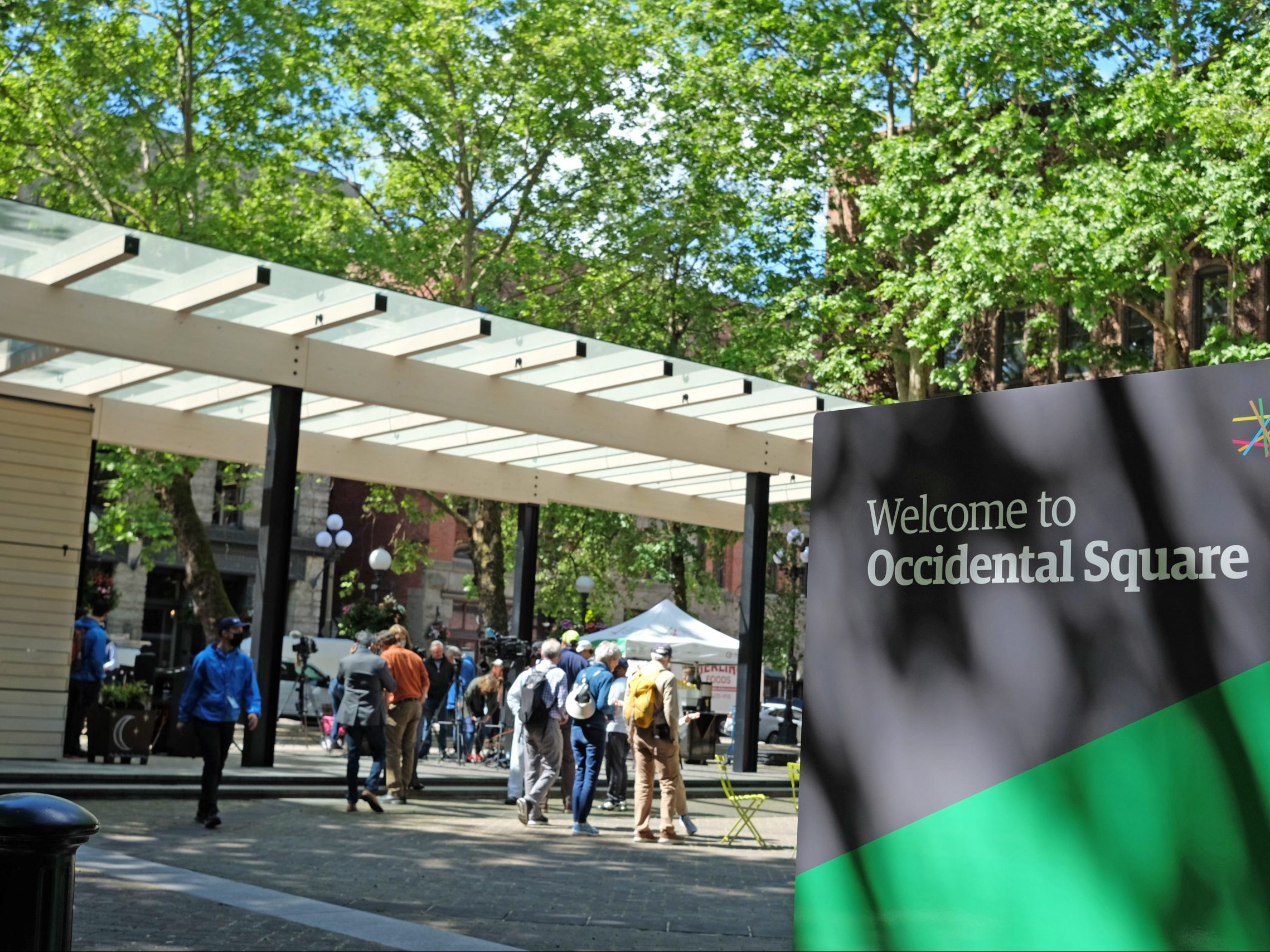 People walk near Occidental Square